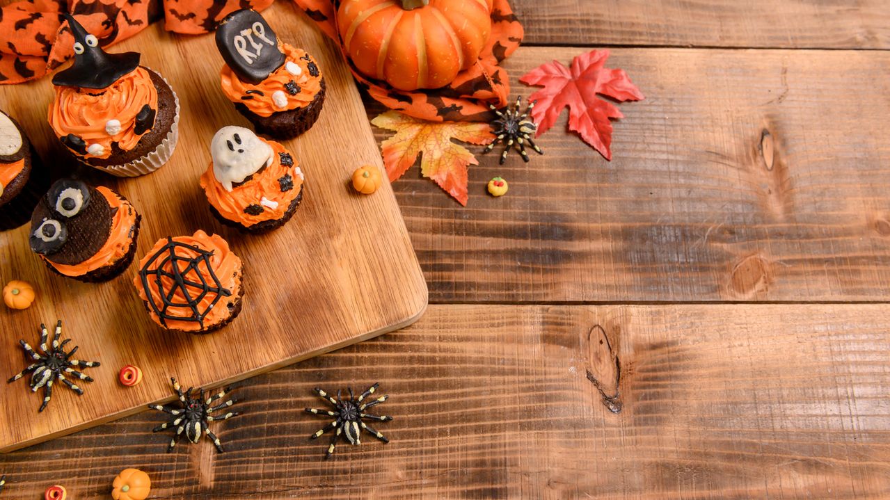 Cooking delicious homemade cake and decorate cupcake for Halloween festive. Sweet dessert and decoration for party at home.
