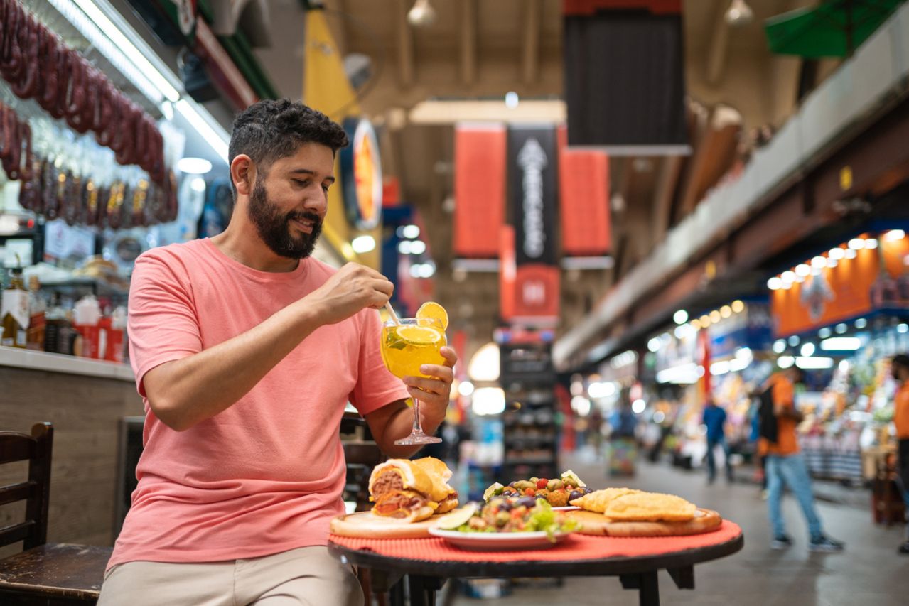 Man drinking drink at municipal market